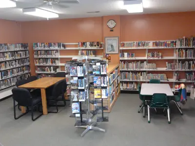 inside Cavendish library with bookshelves and chairs and tables